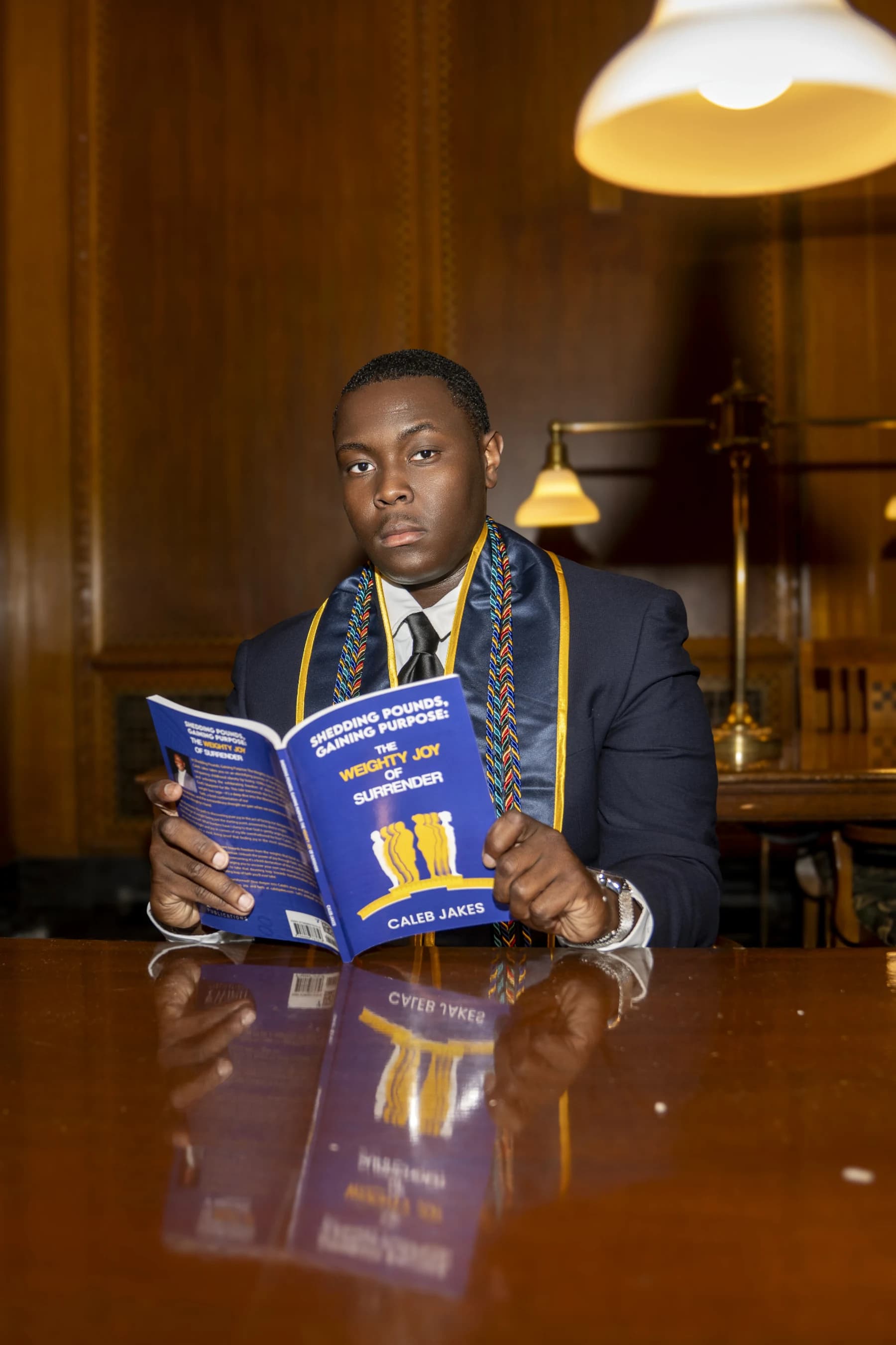 Caleb Jakes holding his book